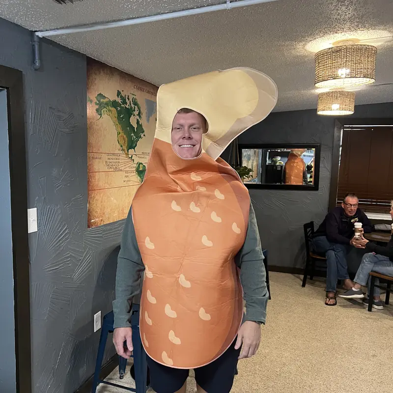 A guest in a Halloween costume inside the shop