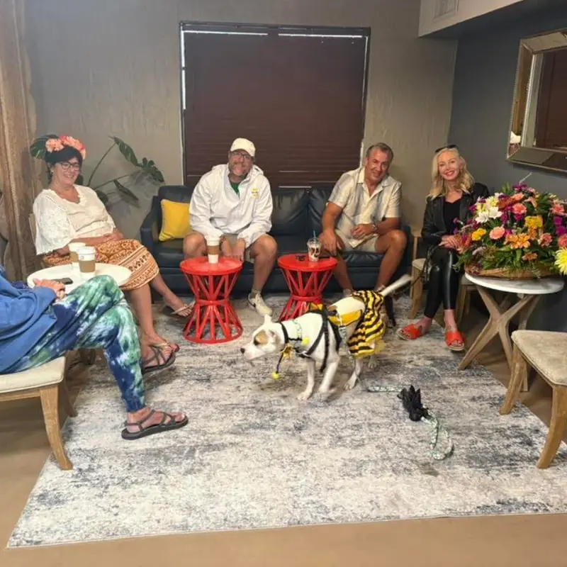 Guests and a costumed dog gathered in the shop lounge