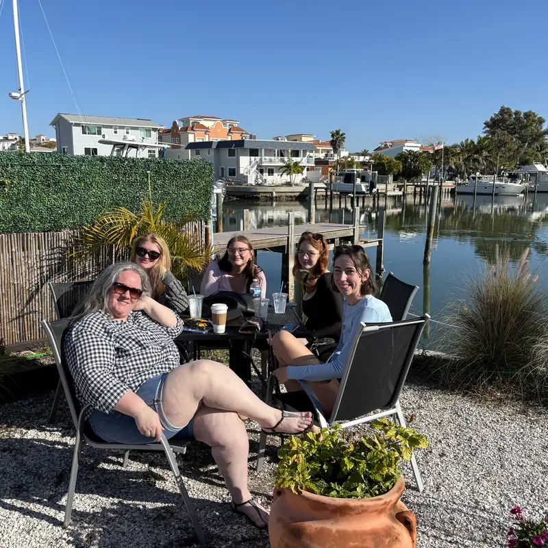 Guests relaxing on the patio by the marina