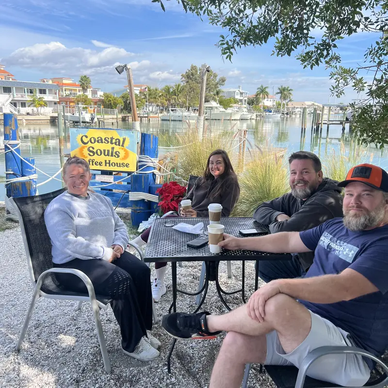 Guests at the patio tables by the marina