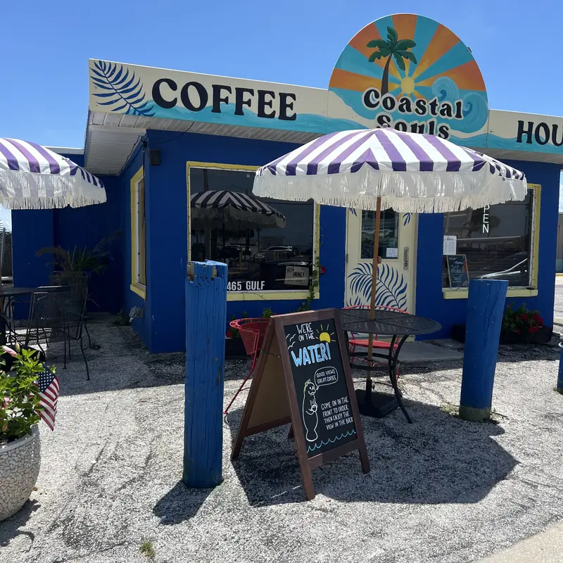 The Coastal Souls storefront with striped umbrellas out front